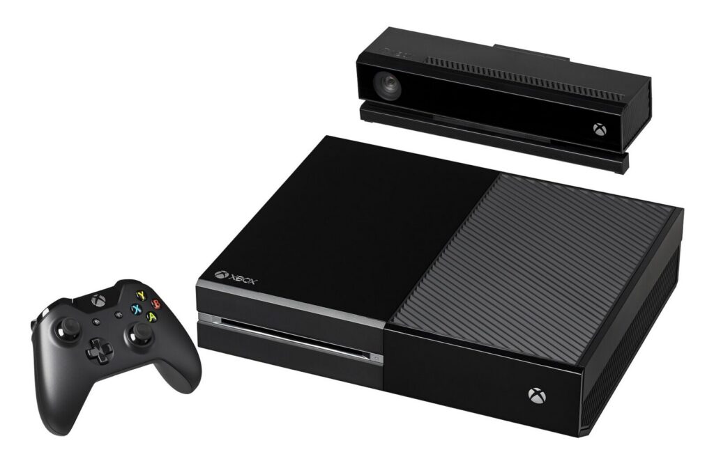 Control de Xbox sobre una mesa junto a un televisor inteligente