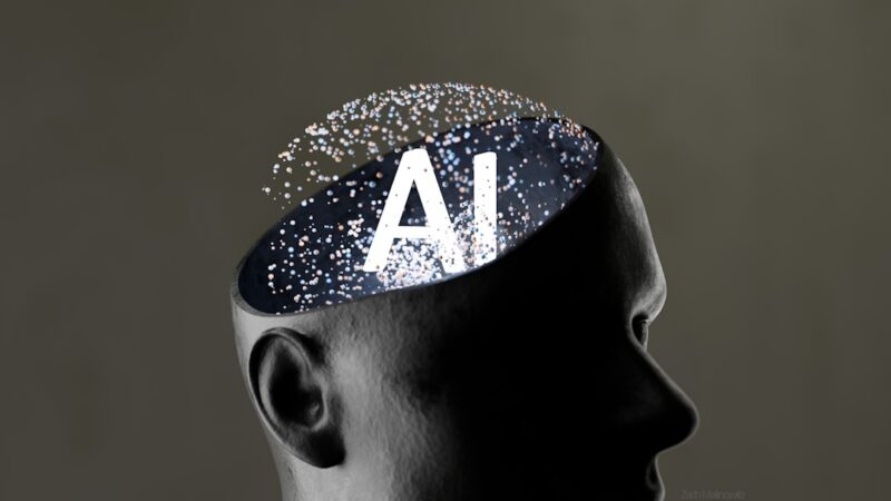 Persona frente a una pantalla de computador en una oficina, en una escena relacionada con inteligencia artificial