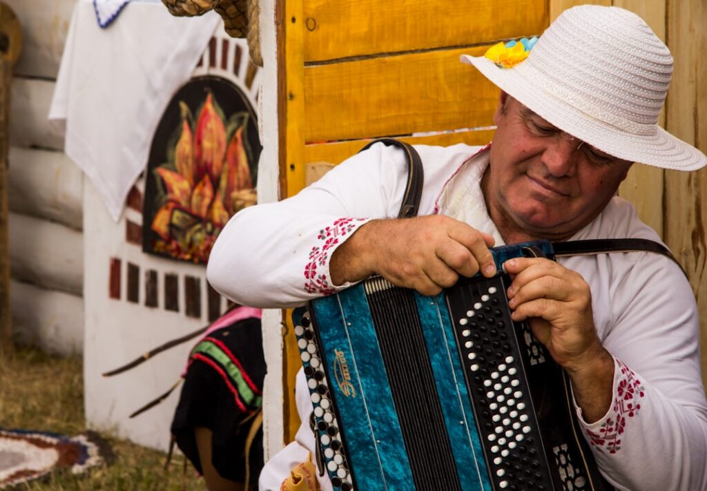 Músico tocando un acordeón en un escenario durante un festival de música vallenata en Colombia