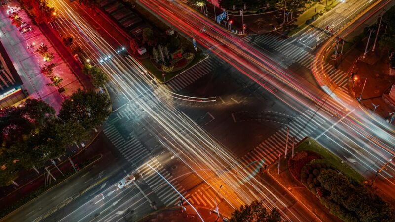 Semáforo en una intersección de una avenida urbana con tráfico de vehículos