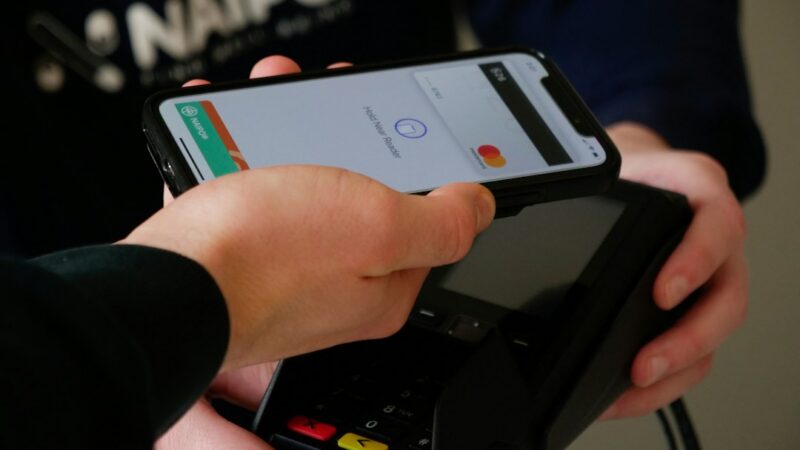 Persona usando la aplicación Nequi en un celular para verificar un comprobante de pago