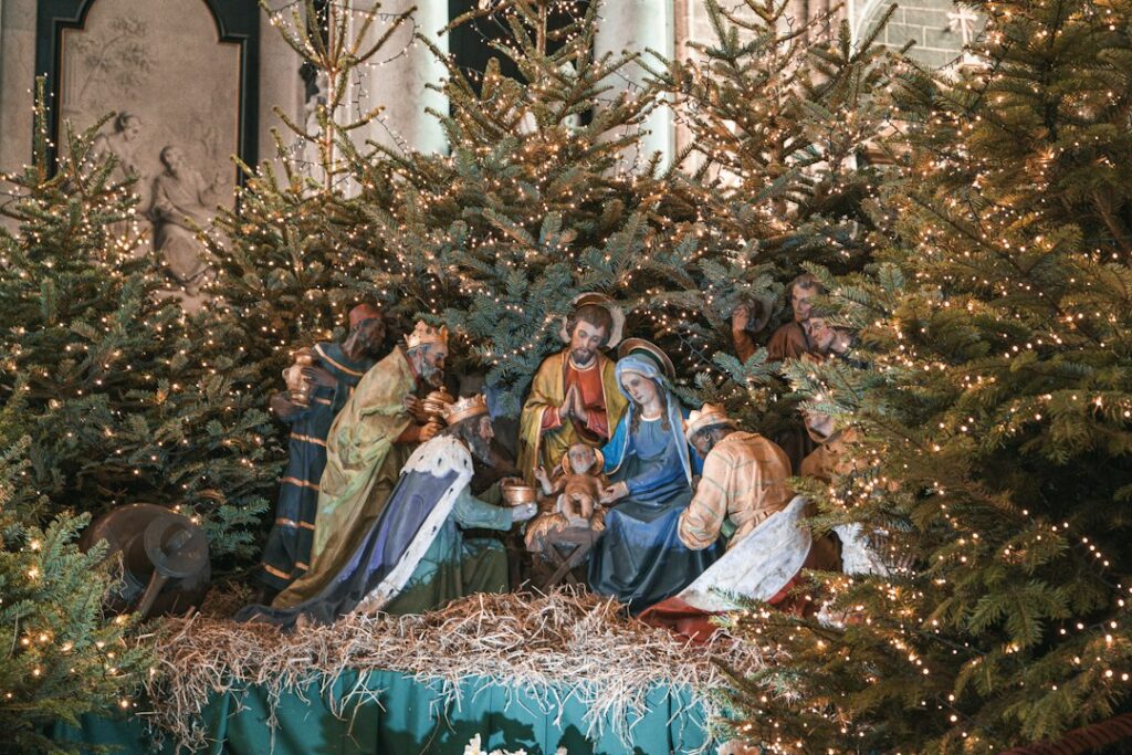 Escenografía navideña con el pesebre y luces encendidas durante la noche