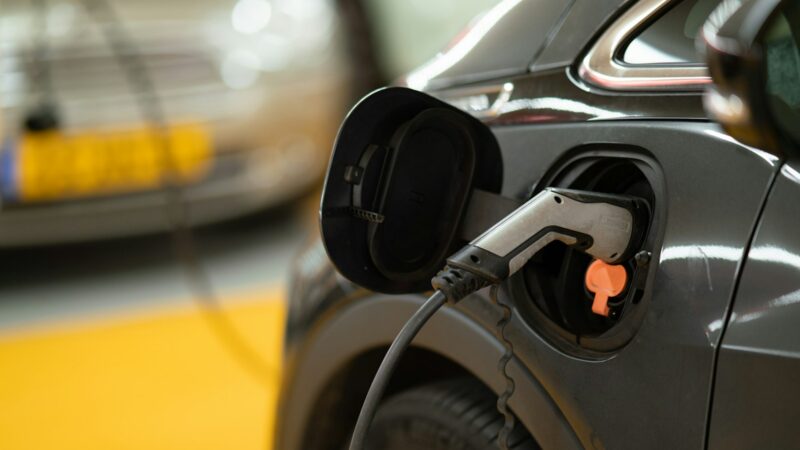 SUV eléctrico conectado a una estación de carga en un entorno urbano