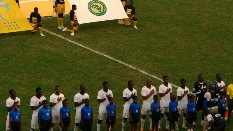 Entrenador de fútbol dirigiendo a una selección desde la zona técnica