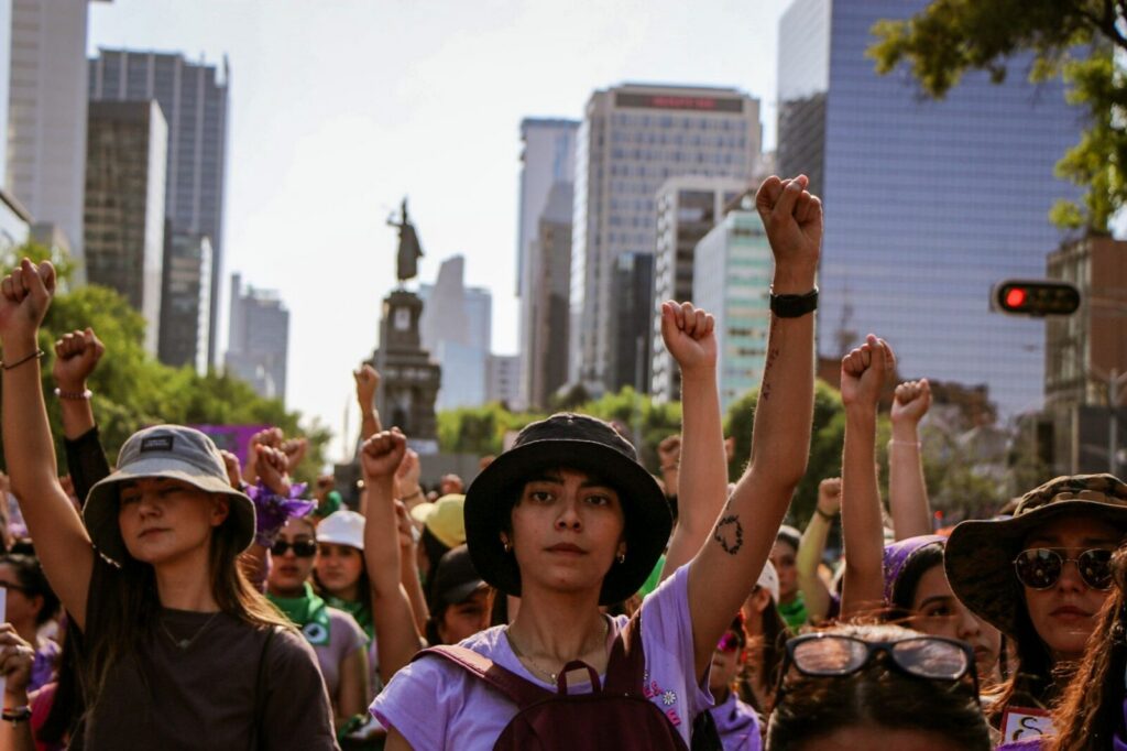 Manifestantes avanzan por una avenida durante una jornada de protesta ciudadana