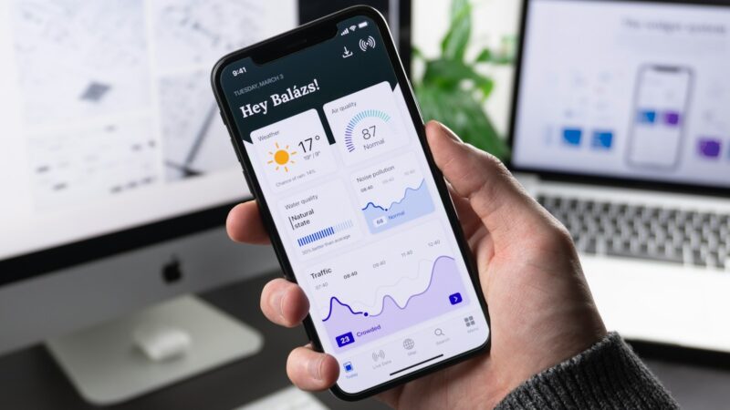 Persona utilizando una aplicación financiera con herramientas de inteligencia artificial en un teléfono