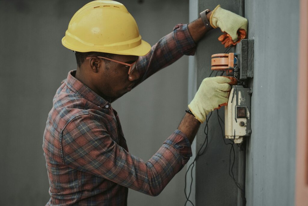 Trabajador instala componentes eléctricos durante la construcción de una vivienda
