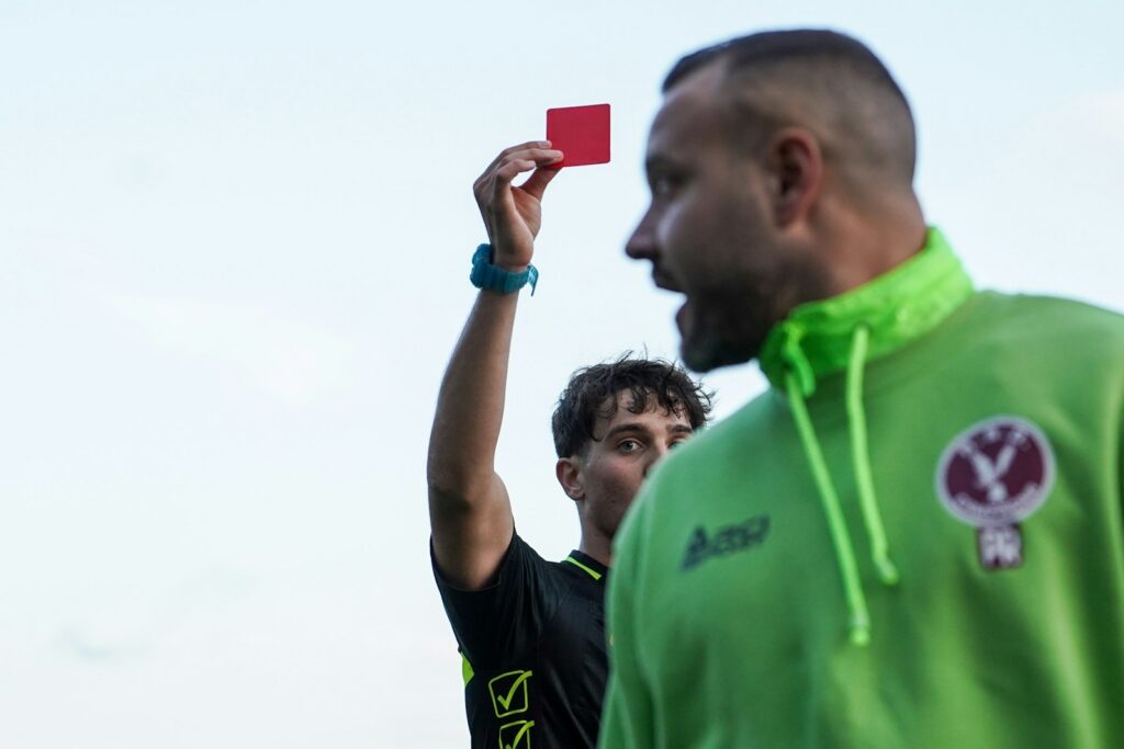 Árbitro muestra una tarjeta roja durante un partido de fútbol
