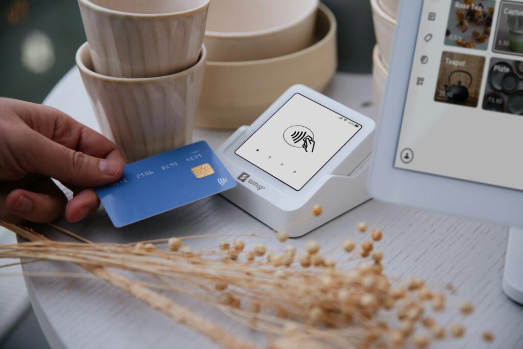 Cliente realizando un pago digital mediante un teléfono celular en un pequeño comercio